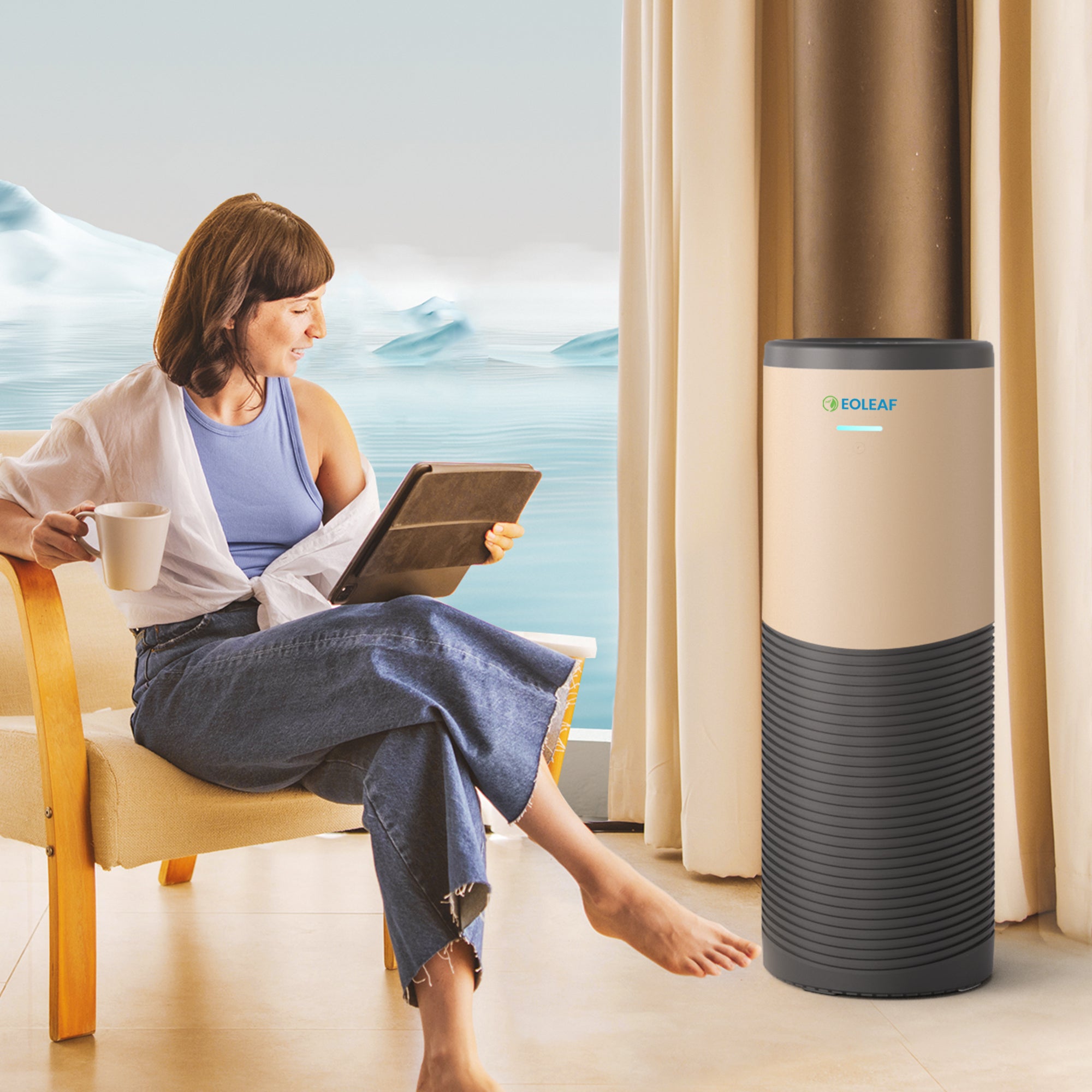 A woman sitting in a chair using her tablet next to Eoleaf's AEROPRO 150 air purifier