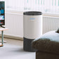 The AEROPRO 100 air purifier in a living room