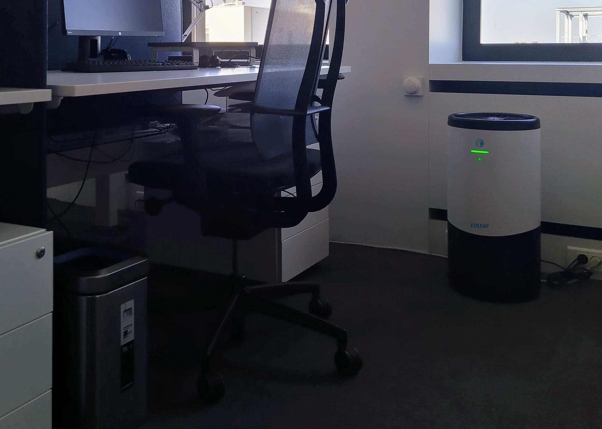 Eoleaf's AEROPRO 100 air purifier next to a desk and chair