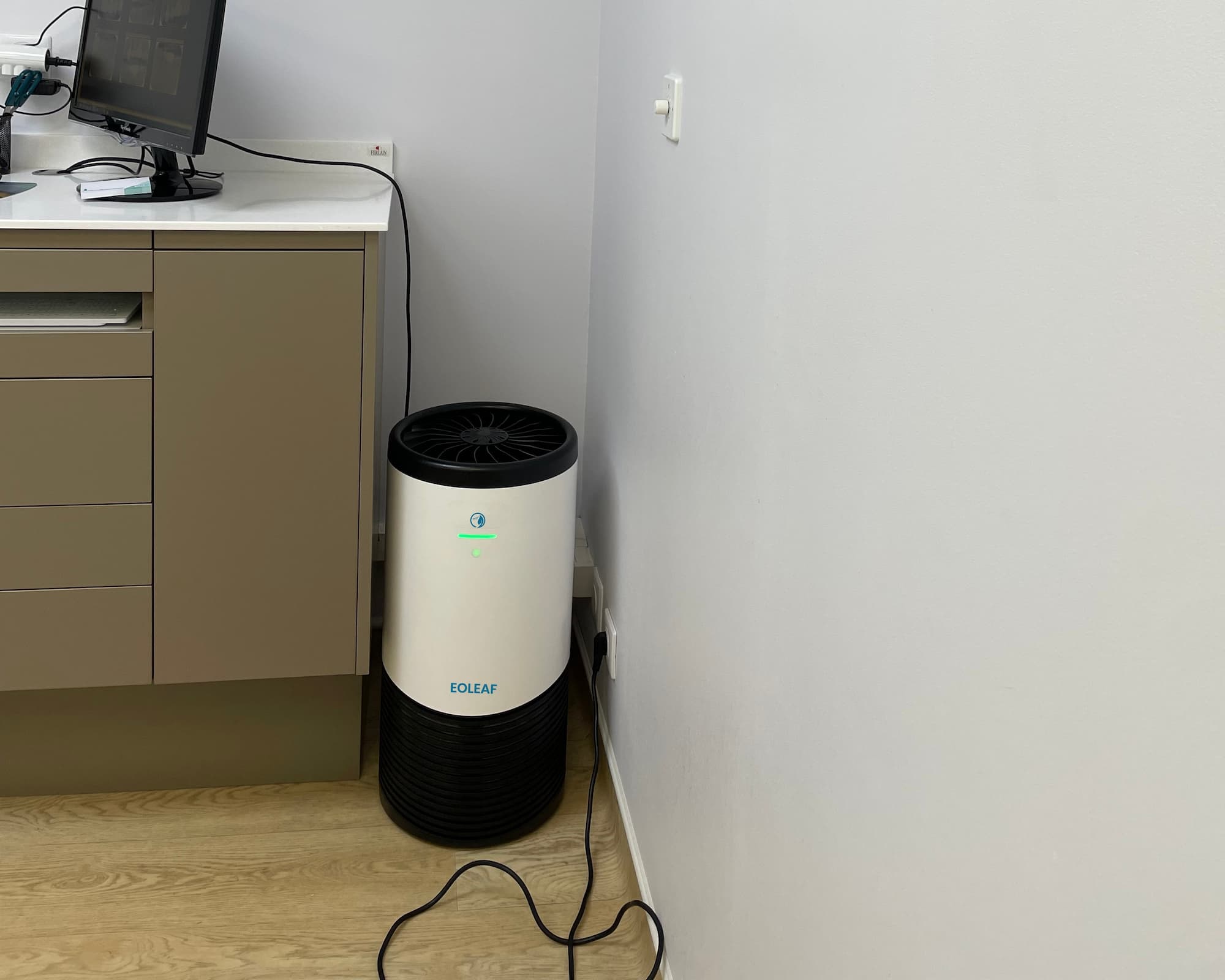 Eoleaf's AEROPRO 100 air purifier in the corner of a doctor's office