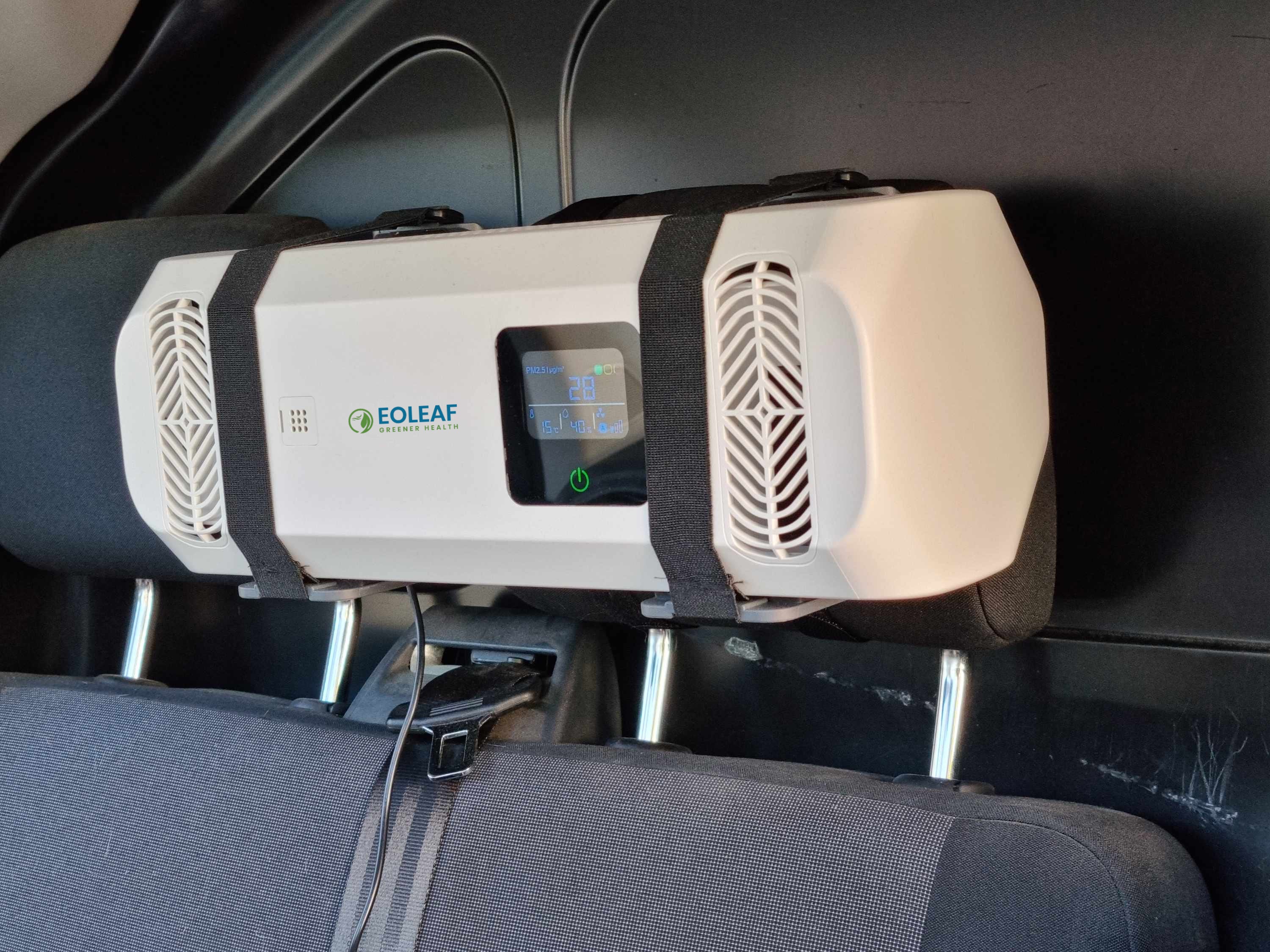 Eoleaf's Pure CAR air purifier attached to a car's headrest